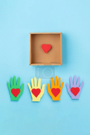 Photo for World Humanitarian Day Concept. Tolerance, kindness, cooperative, friendship, charity, humanitarian aid day concept. Red Hearts and donation box on blue background, copy space, top view. - Royalty Free Image