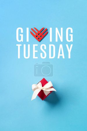 Photo for Giving Tuesday, global day of charitable giving after Black Friday shopping day. Charity, give help, donations support concept. Red paper hearts and gift box on blue background. Top view, copy space. - Royalty Free Image