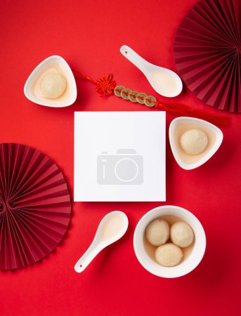 Photo for Sweet rice dumplings balls Tang Yuan for Chinese Dongzhi festival and lunar new year festival food. Winter Solstice day concept on red background. Top view, copy space. - Royalty Free Image