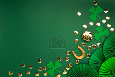 Photo for St. Patrick's Day leprechaun hat, gold coins and shamrocks on green background. Irish traditional holiday concept. Top view, copy space. - Royalty Free Image