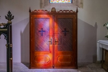 Photo for A confessional inside a church, a private space for the confession of the faithful. - Royalty Free Image