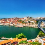 Porto Aerial Cityscape with Luis I Bridge and Douro River during a Sunny Day, Portugal  