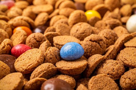 Photo for Dutch holiday Sinterklaas background with pepernoten and traditional colorful sweets strooigoed. Selective focus - Royalty Free Image
