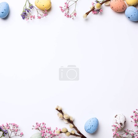 Photo for Border with Easter composition with spring flowers and colorful quail eggs over white background. Springtime and Easter holiday concept with copy space. Top view - Royalty Free Image