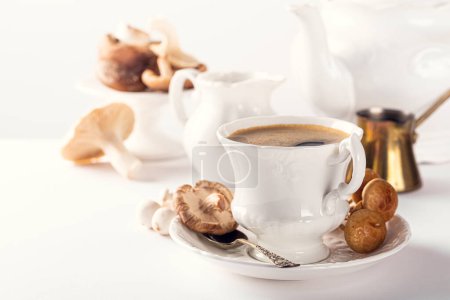 Photo for Trendy mushroom coffee in white porcelain vintage cup over white background. New Superfood Trend. Copy space, selective focus. - Royalty Free Image
