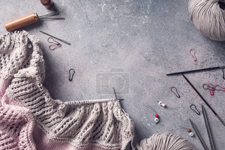 Photo for Knitting flat lay with pink wool yarn and knit accessories over gray, top view, overhead shot with copy space. Retro style toned - Royalty Free Image