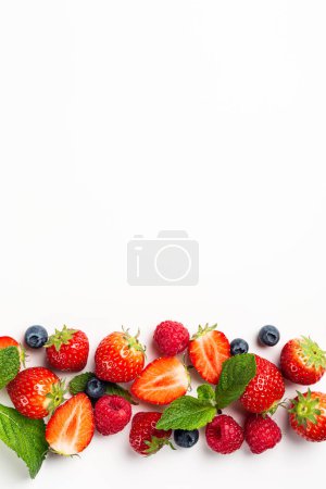 Photo for Stripe of berries with strawberry, raspberry and blueberry on white background, top view, flat lay. Healthy food concept with copy space - Royalty Free Image