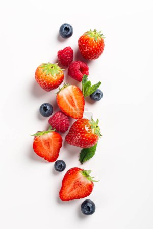 Photo for Summer composition with strawberry, raspberry and blueberry on white background, top view, flat lay. Creative food concept with copy space - Royalty Free Image