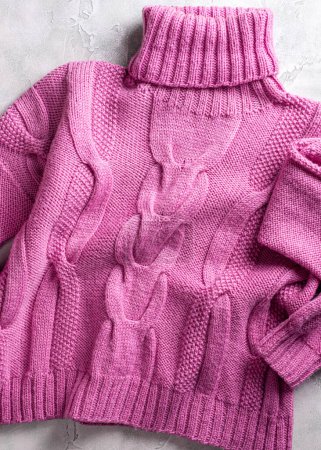 Photo for Pink handemade knitted wool women high collar cable knit sweater, roll neck jumper. Top view. Modern jersey apparel for ladys and girls - Royalty Free Image