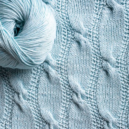 Photo for Unusual abstract turquoise cable knitted pattern background texture. Top view of knitting clothes en ball yarn - Royalty Free Image