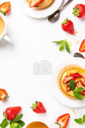 Photo for Beautiful composition of strawberry mini cakes tartlet with vanilla custard and mint leaves sprinkled with almond flakes over white background. Concept of homemade sweet pastries. Copy space, top view - Royalty Free Image