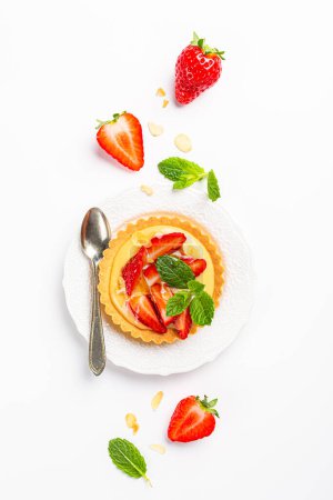 Photo for Flat lay composirion with strawberry mini cake tartlet with vanilla custard, sprinkled with almond flakes and mint leaves over white background. Concept of homemade healthy sweet pastries. Top view - Royalty Free Image
