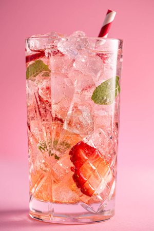 Photo for Fresh healthy limonate cocktail with crushed ice, strawberry and mint on pinkbackground. Summer cold drink concept, close up shot - Royalty Free Image