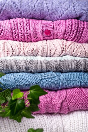 Photo for Home wardrobe with winter clothes. Stack of woolen knitted warm wool sweaters. Autumn, winter season handmade knitwear - Royalty Free Image