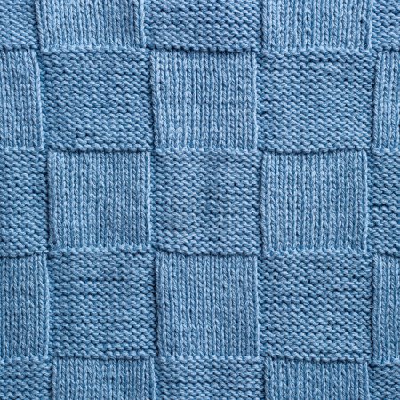 Photo for Unusual abstract blue knitted chess pattern background texture. Top view of knitting clothes - Royalty Free Image