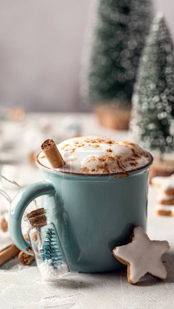Photo for Christmas drink. Cup of hot chocolate with cinnamon in blue mug and gingerbread stars cookies with white glaze and decoration, copy space. Story template and phone background format - Royalty Free Image