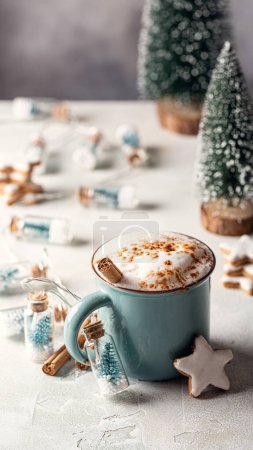 Photo for Pumpkin spice latte in blue mug and gingerbread stars cookies with white glaze and winter decor. Story template and phone background format - Royalty Free Image