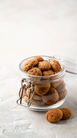 Photo for Kruidnoten cookies in glass jar. Pepernoten, traditional sweets, strooigoed. Dutch holiday Sinterklaas greetings card concept Saint Nicholas day, copy space. Story template and phone background format - Royalty Free Image