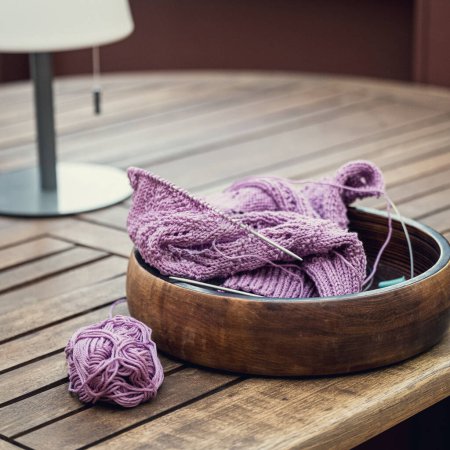 Photo for Knitting project of knitting womens pink sweater in progress. Cozy homely atmosphere with wooden table. Toned photo - Royalty Free Image