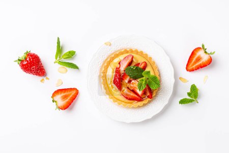 Photo for Beautiful composirion with strawberry mini cake tartlet with vanilla custard, sprinkled with almond flakes and mint over white. Concept homemade healthy sweet pastries with copy space and above view - Royalty Free Image