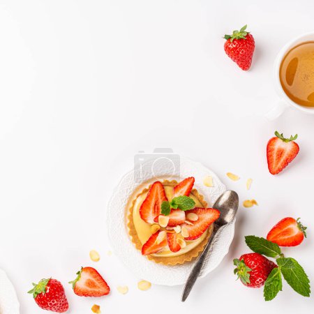 Photo for Summer composirion with strawberry mini cake tartlet with vanilla custard, sprinkled with almond flakes and mint over white. Concept of high tea healthy sweet pastries with copy space - Royalty Free Image