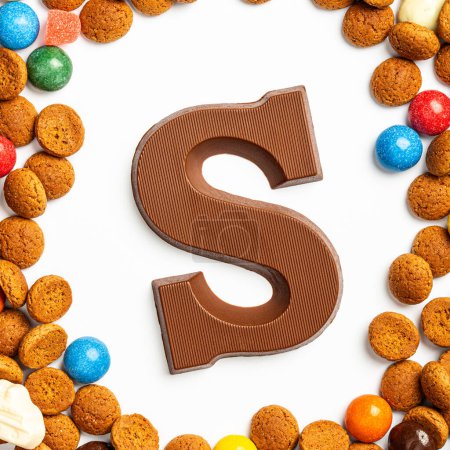 Photo for Concept for greeting card for Dutch holiday Sinterklaas. Kruidnoten, chocolate letter S, cookies and traditional hollands sweets. Concept for children party Saint Nicolas day five december. Top view. - Royalty Free Image