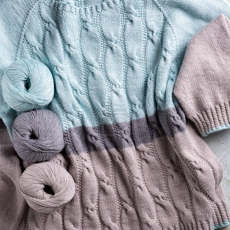 Photo for Beautiful classical casual turquoise gray women jumper with cables texture and balls yarn. Stylish cotton pullover with simple pattern and long sleeves front view. Overhead view - Royalty Free Image