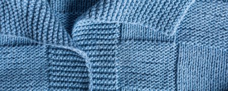 Photo for Close up view banner of handemade knitted blue women jumper with polo collar. Stylish cotton pullover with chess texture pattern and long sleeves front view. Top view - Royalty Free Image