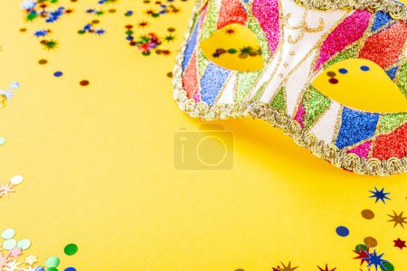 Photo for Festive yellow background with colorful carnival mask. Greeting card concept for birthday, carnival, party. Copy space, top view, flat lay. - Royalty Free Image