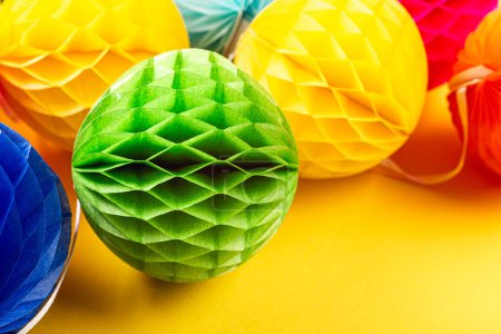 Photo for Festive yellow background with colorful paper balls. Greeting card concept for birthday, party, invitation, carnival. Copy space, top view, flat lay. - Royalty Free Image