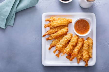 Tempura shrimp on a plate served with sweet and sour sauce and soy sauce, appetizer idea
