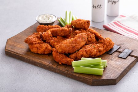 Buffalo chicken fingers served with ranch sauce and celery