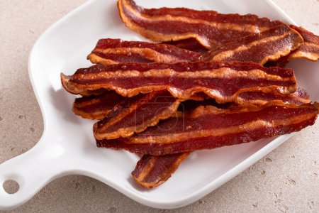 Turkey bacon crispy cooked on a white plate ready to eat