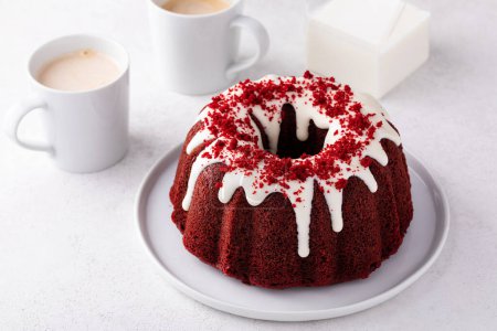 Photo for Red velvet bundt cake with cream cheese frosting and cake crumbs on top - Royalty Free Image