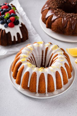 Photo for Variety of bundt cakes on the table with lemon, chocolate and berry cakes - Royalty Free Image