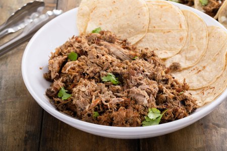 Photo for Pork carnitas tacos on a cutting board with onion and cilantro - Royalty Free Image