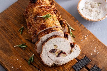 Roasted pork loin stuffed with cranberry and apples with rosemary