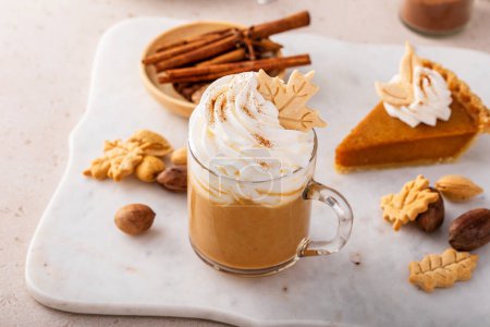 Photo for Pumpkin spice latte in a mug topped with whipped cream and cinnamon - Royalty Free Image