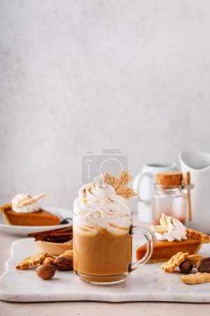 Photo for Pumpkin spice latte in a mug topped with whipped cream and cinnamon - Royalty Free Image