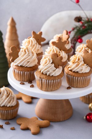 Photo for Gingerbread cupcakes with warm winter spices topped with little gingerbread cookies, dessert idea for Christmas - Royalty Free Image