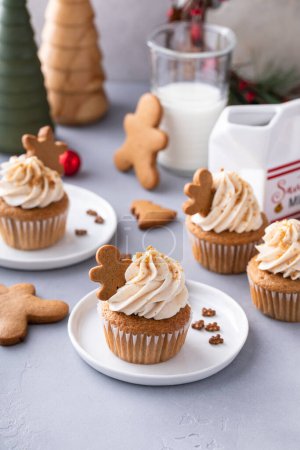 Photo for Gingerbread cupcakes with warm winter spices topped with little gingerbread cookies, dessert idea for Christmas - Royalty Free Image
