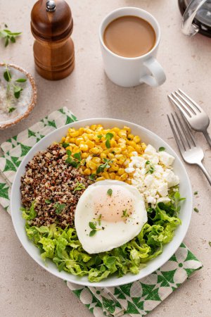 Photo for Breakfast bowl with quinoa, herbed corn, feta cheese and fried egg on top - Royalty Free Image