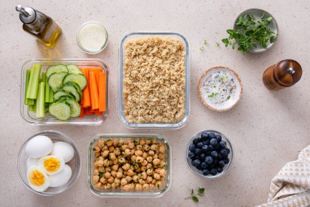Photo for Vegetarian lunch meal prep in containers, high protein meal prep with quinoa, herbed chickpeas, vegetables and boiled eggs - Royalty Free Image