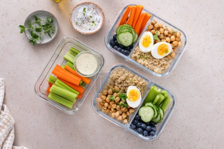 Photo for Vegetarian lunch meal prep containers high protein with quinoa, herbed chickpeas, vegetables and boiled eggs - Royalty Free Image