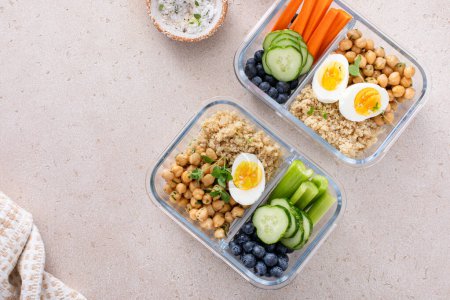 Photo for Vegetarian lunch meal prep containers high protein with quinoa, herbed chickpeas, vegetables and boiled eggs - Royalty Free Image