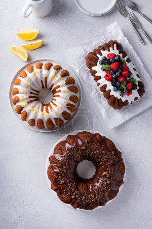Variety of homemade bundt cakes and loaf cakes ready to eat overhead view
