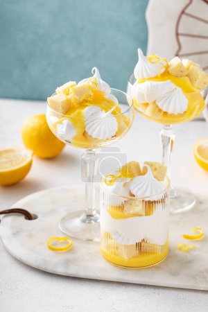 Lemon parfait or eton mess with lemon curd, meringue kisses, whipped cream and pound cake