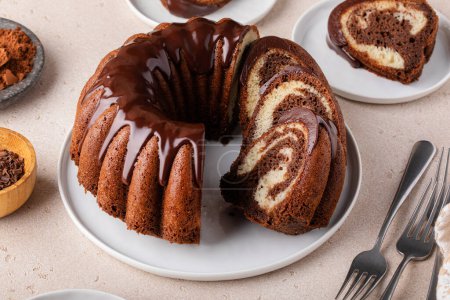 Marbled bundt cake sliced on a plate, chocolate and vanilla cake
