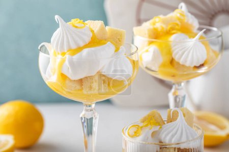Lemon parfait or eton mess with lemon curd, meringue kisses, whipped cream and pound cake
