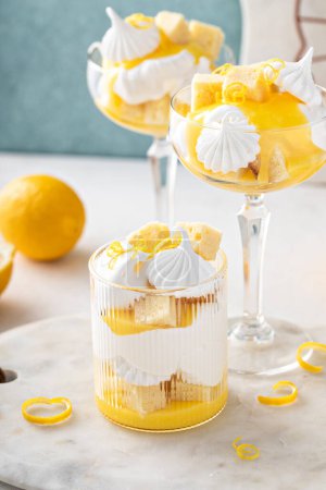 Photo for Lemon trifle with pound cake, lemon curd, whipped cream and meringue in coupe glasses - Royalty Free Image